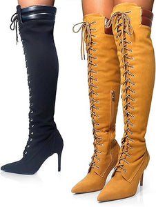 Yellow and black knee-high boots with lace-up design on a white background