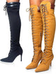 Yellow and black knee-high boots with lace-up design on a white background